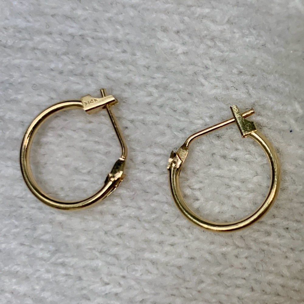 14 K gold stamped petite hoop earrings.